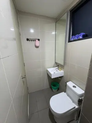 a bathroom with a toilet and a sink and a mirror at Queen Room At KL Gateway Residence LRT Linked in Kuala Lumpur