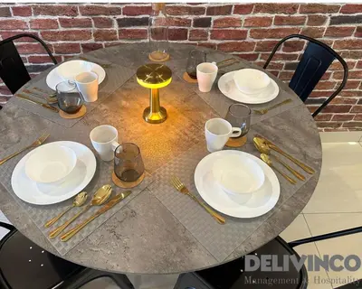 a table with plates and utensils on it at Trion - 2BR - 6pax - KL - 9mins - IKEA & Velocity in Kuala Lumpur
