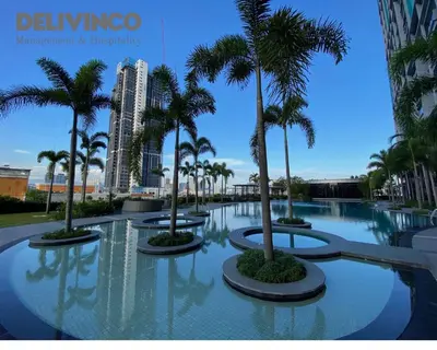 a pool with palm trees in a resort at Trion - 2BR - 6pax - KL - 9mins - IKEA & Velocity in Kuala Lumpur