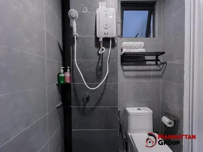 a shower in a bathroom with a toilet and a mirror at Neu Suites By Manhattan Group in Kuala Lumpur