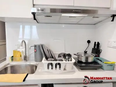 a kitchen counter with a sink and a stove at Neu Suites By Manhattan Group in Kuala Lumpur