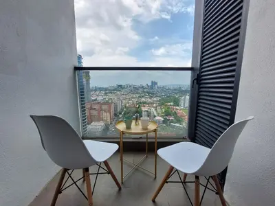 a room with two chairs and a table and a large window at KL Sentral, Est Bangsar#11, 7Pax in Kuala Lumpur