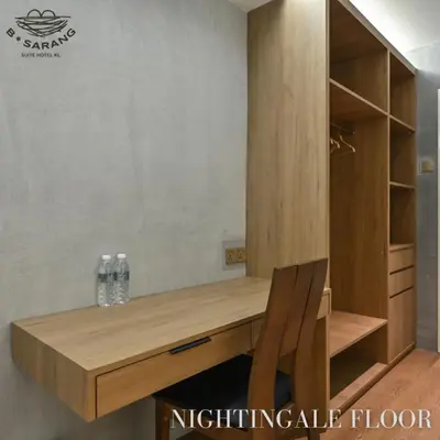 a wooden desk in a room with a mirror at B Sarang Suite Hotel Kuala Lumpur in Kuala Lumpur