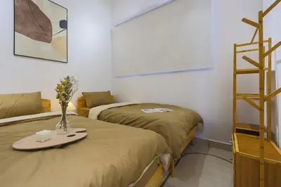 a room with two beds and a shelf with a tray at 10 min to My town family unit By Nexx Field in Kuala Lumpur