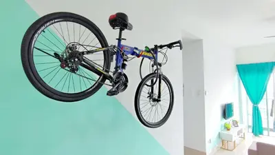 a bike hanging from a wall in a room at YOLO Budget Condo KL 5.0 in Kuala Lumpur