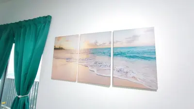 four paintings of the ocean on a wall next to a window at YOLO Budget Condo KL 5.0 in Kuala Lumpur