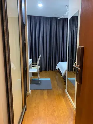 a room with a bed and a chair and a mirror at sky suite klcc in Kuala Lumpur