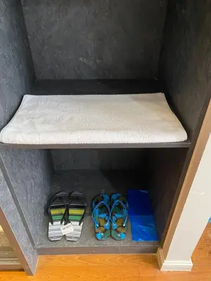 a shelf with some ties and books on it at sky suite klcc in Kuala Lumpur