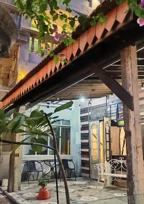 a house with a patio with a table and chairs at Bestow Boutique Hotel in Kuala Lumpur