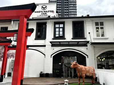 a statue of a cow in front of a building at M101 KLCC KL city King Suites by Livin in Kuala Lumpur