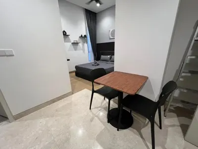 a room with a table and two chairs and a bed at Lucentia Residence At Kuala Lumpur By Dreamcloud in Kuala Lumpur