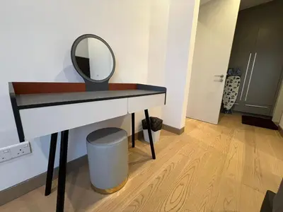 a dressing table with a mirror and a trash can at Lucentia Residence At Kuala Lumpur By Dreamcloud in Kuala Lumpur