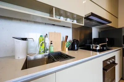 a kitchen with a sink and a counter top at Lucentia Residence At Kuala Lumpur By Dreamcloud in Kuala Lumpur