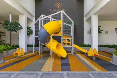 a playground in a building with a yellow slide at Quill Residences Kuala Lumpur, Five Senses in Kuala Lumpur