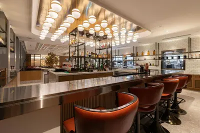 a bar with brown chairs at a restaurant at Crowne Plaza Kuala Lumpur City Centre by IHG in Kuala Lumpur
