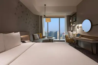 a hotel room with a bed and a large window at Crowne Plaza Kuala Lumpur City Centre by IHG in Kuala Lumpur