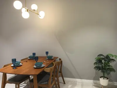 a dining room with a wooden table and chairs at Quill Residence KLCC in Kuala Lumpur
