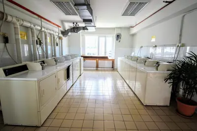 a bathroom with a row of sinks and toilets at Electus Suite in Kuala Lumpur