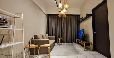 a living room with a couch and a tv at Electus Suite in Kuala Lumpur