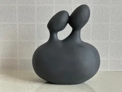 a black vase with two rabbit heads on a table at Robertson Bukit Bintang with Netflix,TRX,KLCC in Kuala Lumpur