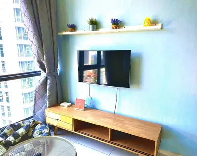 a living room with a flat screen tv on a wall at Robertson Bukit Bintang with Netflix,TRX,KLCC in Kuala Lumpur