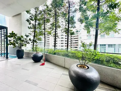 three large black vases sitting on a balcony with trees at One Bukit ceylon @ Bukit Bintang City Centre in Kuala Lumpur