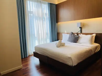 a bedroom with a bed with a teddy bear on it at Tribeca Serviced Hotel by Millennium in Kuala Lumpur