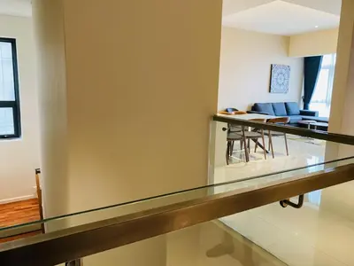 a glass counter in a living room with a dining room at Tribeca Serviced Hotel by Millennium in Kuala Lumpur