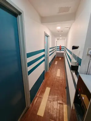 a hallway with blue and white stripes on the walls at V Hotel Titiwangsa in Kuala Lumpur