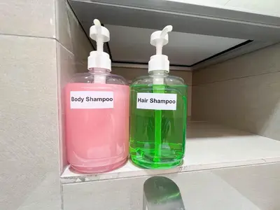 two bottles of soap sitting on a shelf at MH Maison by Manhattan Group in Kuala Lumpur
