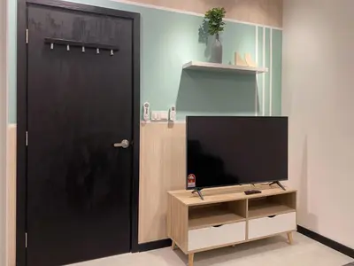 a black door with a tv and a tv stand at Neu Suite by JS Home in Kuala Lumpur