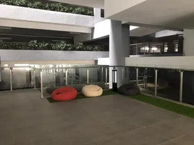 a building with several pillows sitting on the ground at Neu Suite by JS Home in Kuala Lumpur