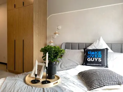 a bed with a tray with a plant on it at Neu Suites by JS Home in Kuala Lumpur