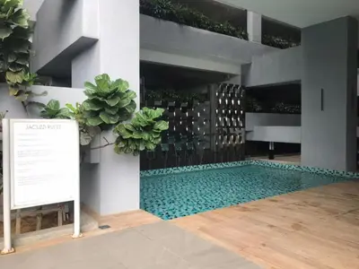a swimming pool with a sign in front of a building at Neu Suites by JS Home in Kuala Lumpur