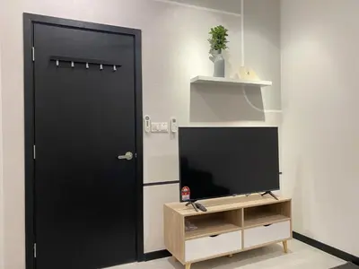 a black door in a room with a television at Neu Suites by JS Home in Kuala Lumpur