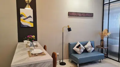 a dining room with a table and a blue chair at Chambers Service Suites KLCC By Cozy Stay in Kuala Lumpur