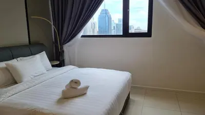 a teddy bear sitting on a bed in a hotel room at Chambers Service Suites KLCC By Cozy Stay in Kuala Lumpur