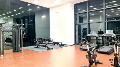 a gym with several treadmills and cardio machines at Chambers Service Suites KLCC By Cozy Stay in Kuala Lumpur