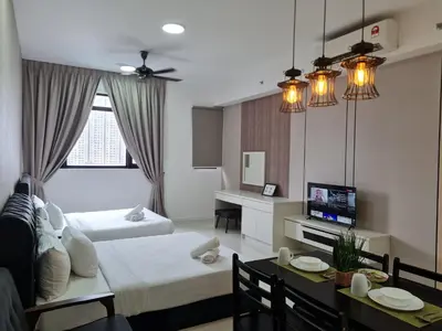 a living room with a bed and a dining room at Chambers Suites KL BY Fortune in Kuala Lumpur