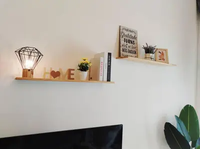 two shelves above a fireplace with books and plants at PWTC Titiwangsa HKL near MRT family in Kuala Lumpur