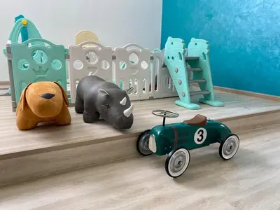 a childs room with toys on a wooden floor at KL Panorama View City in Kuala Lumpur