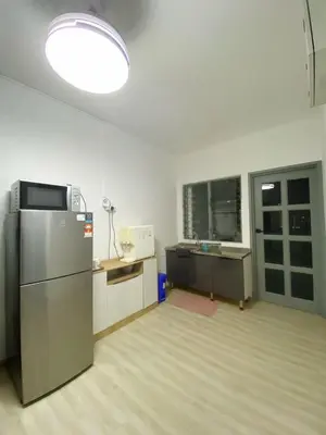 an empty kitchen with a refrigerator in a room at KL Panorama View City in Kuala Lumpur