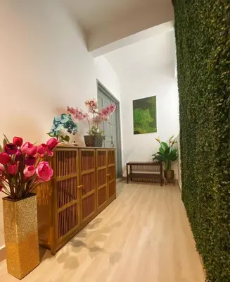 a living room with flowers and plants on a wall at KL Panorama View City in Kuala Lumpur