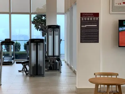 a gym with a treadmill and a bench and a table at Platinum KLCC & Bukit Bintang in Kuala Lumpur