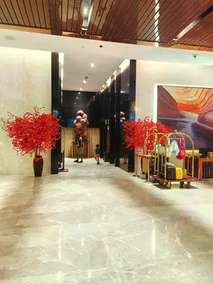 a lobby with red potted plants in a building at Platinum KLCC & Bukit Bintang in Kuala Lumpur