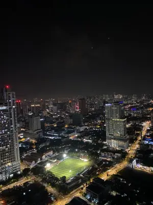 a view of a city at night with a soccer field at Platinum KLCC & Bukit Bintang in Kuala Lumpur