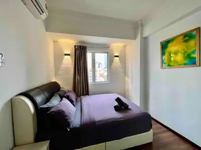 a bedroom with a bed and a couch and a window at Couple Suite at Casa Mutiara 5 mins walk to LRT, Jalan Alor and Bukit Bintang in Kuala Lumpur