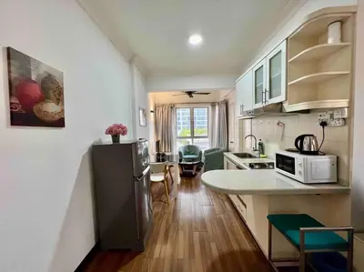a kitchen with a refrigerator and a counter top at Couple Suite at Casa Mutiara 5 mins walk to LRT, Jalan Alor and Bukit Bintang in Kuala Lumpur