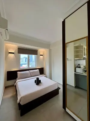 a bedroom with a large bed and a large mirror at Couple Suite at Casa Mutiara 5 mins walk to LRT, Jalan Alor and Bukit Bintang in Kuala Lumpur
