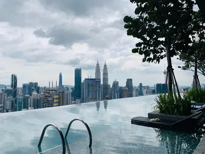 a infinity pool with a view of a city at Expressionz Premium Suites @ KLCC in Kuala Lumpur
